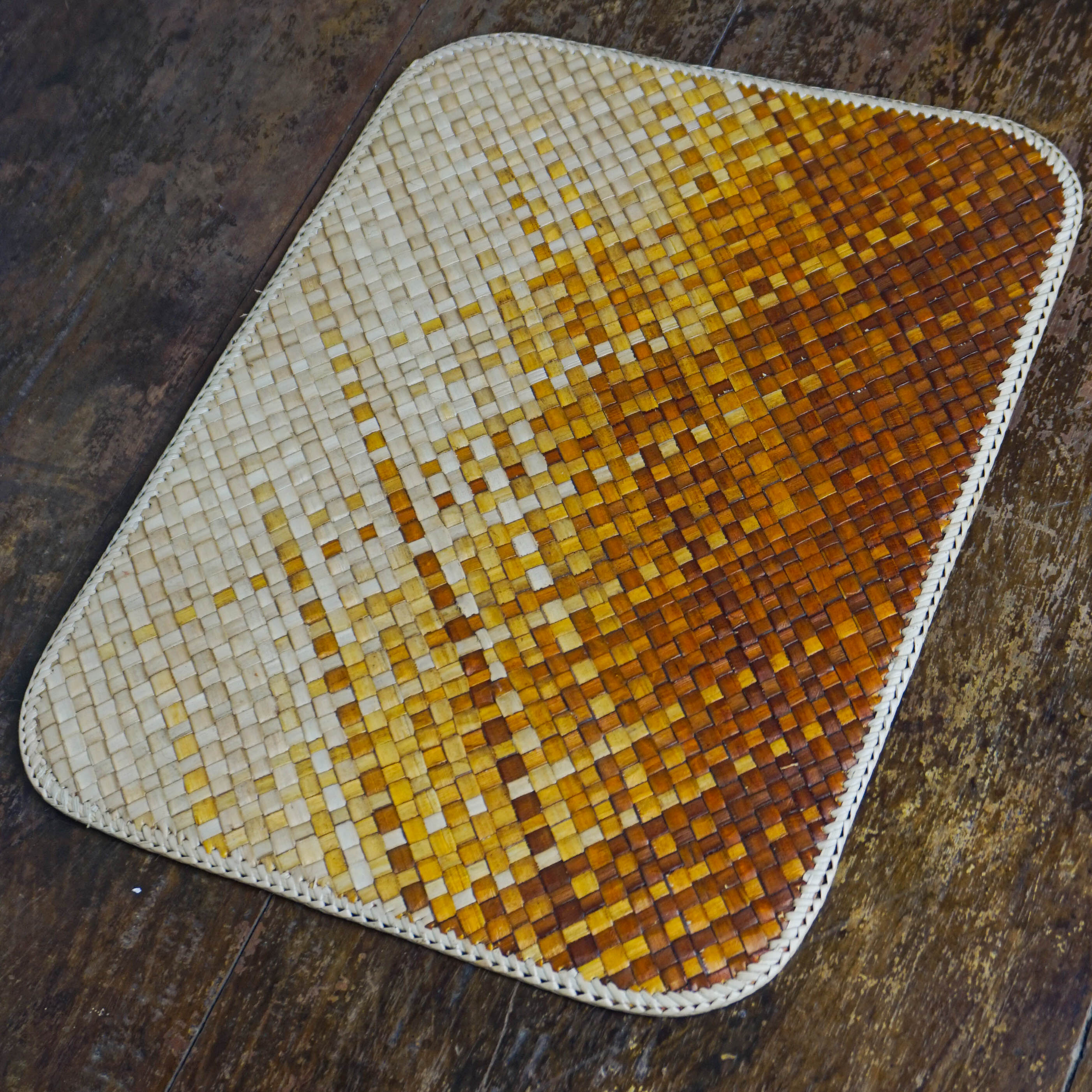 Hand-woven fiber-mosaic placemats in amber and indigo